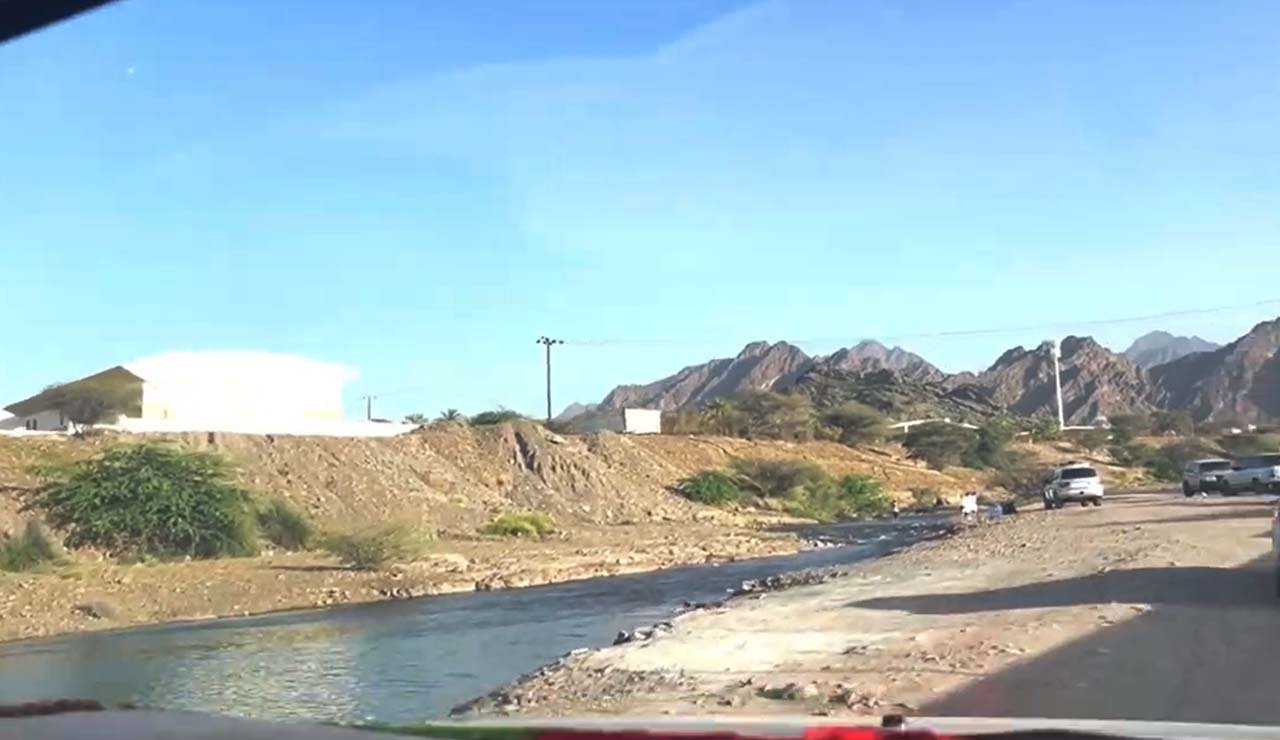 Swan Lake Hatta early morning with mountains in the background